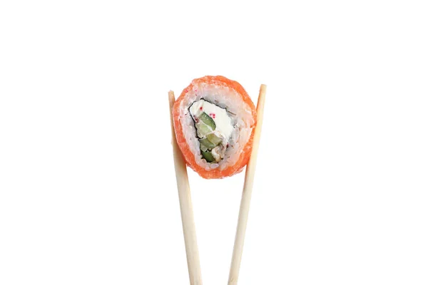 Japanese cuisine. One peace of sushi roll in wooden chopsticks isolated on white background. — Stockfoto