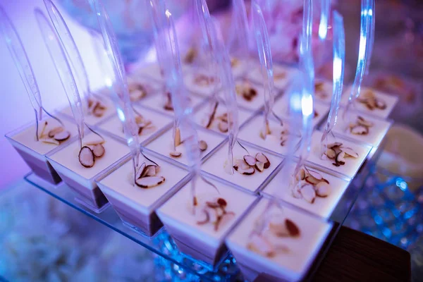Candy bar on wedding ceremony with a lot of different cupcakes, modern desserts, mousses and jellies. selective focus — Stockfoto