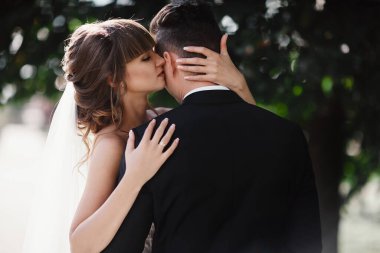 portrait of happy stylish couple on their wedding day outdoors