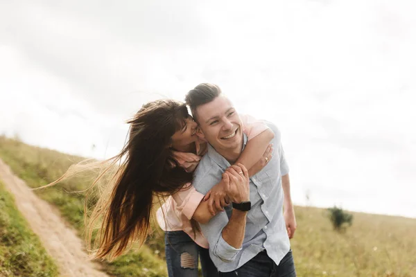 Amar jovem casal beijando e abraçando ao ar livre. Amor e ternura, namoro, romance, família, conceito de aniversário . — Fotografia de Stock