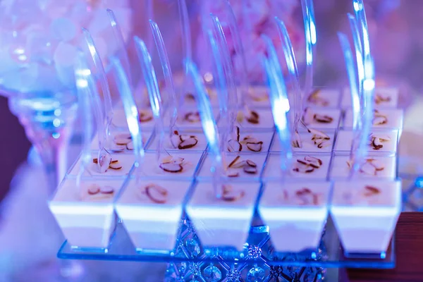 Candy bar on wedding ceremony with a lot of different cupcakes, modern desserts, mousses and jellies. selective focus — Stockfoto