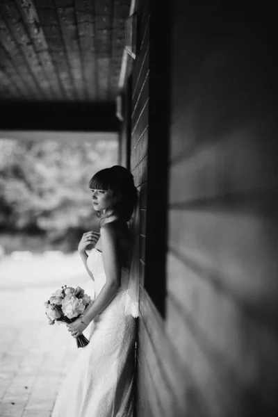 Black and white photo. elegant bride in white dress posing. Bride portrait wedding makeup and hairstyle, fashion bride. wedding day. noise and grain in the photo