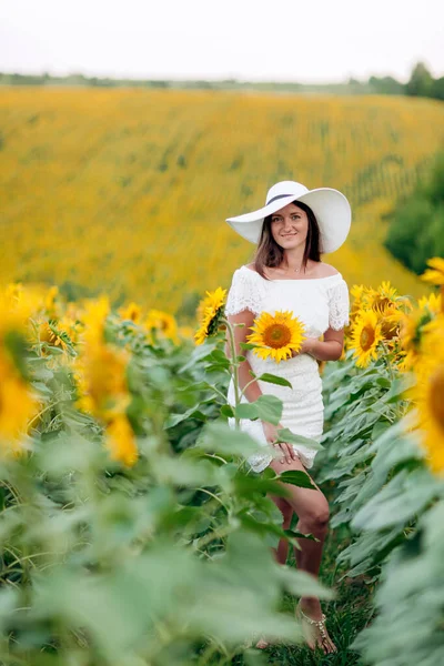Beyaz Elbiseli Ayçiçeği Tarlasında Şapkalı Mutlu Bir Genç Kadın Güneş — Stok fotoğraf