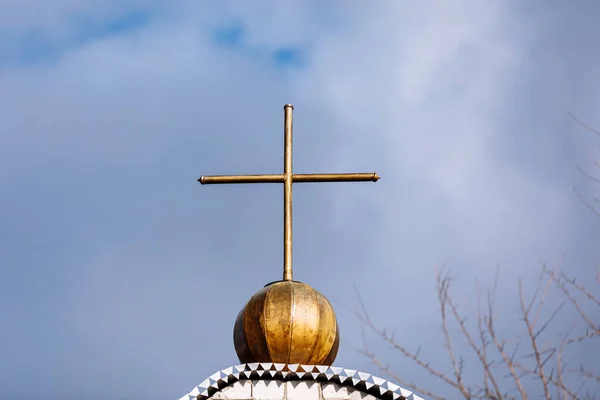 Orthodox church cross on a background of blue sky with clouds. Easter. Christmas. Place for text. Background image. Religion. selective focus.
