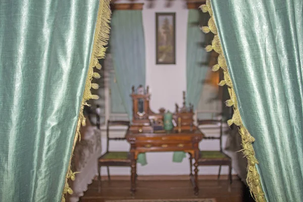 Master bedroom in a village house, beginning of the 19th century, curtains on the door to the bedroom.