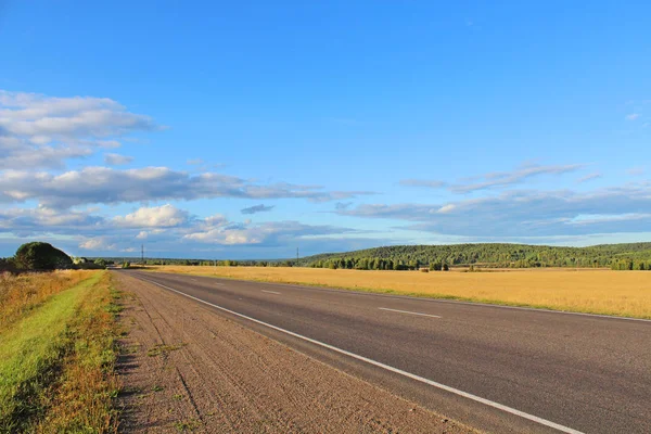 stock image Road in the steppe, landscape, wide view, lots of bright sky, rich colors, the concept of autotravels.