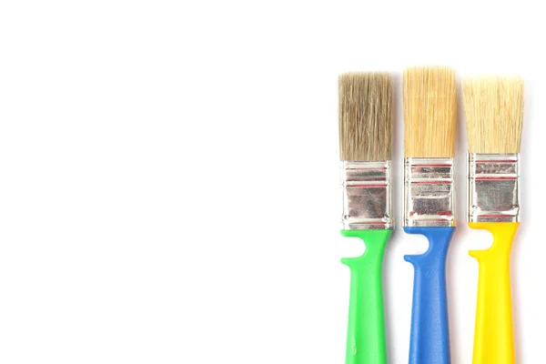 Colored paint brushes with plastic handles on a white background, place for text, isolate, flat layer, close-up. — 스톡 사진