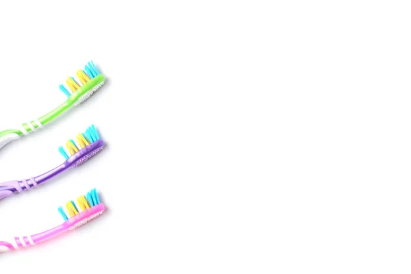 Flat lay, toothbrushes colored on a white background close-up , copy space. — Stock Photo, Image