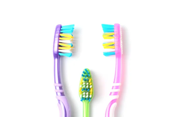 Colored toothbrushes on a white background close-up, family hygiene concept. — Stock Photo, Image
