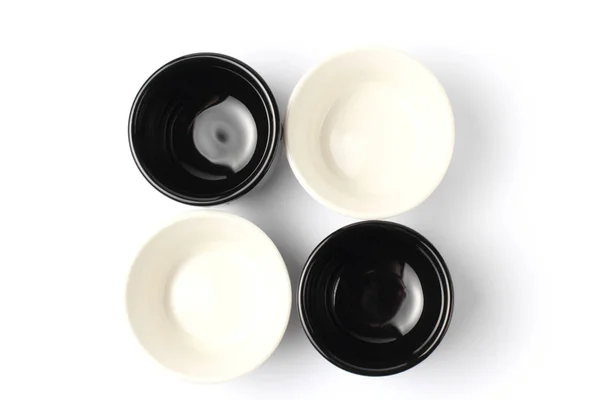 Flat lay, black and white ceramic dishes for sauce on a white background close-up. — 스톡 사진