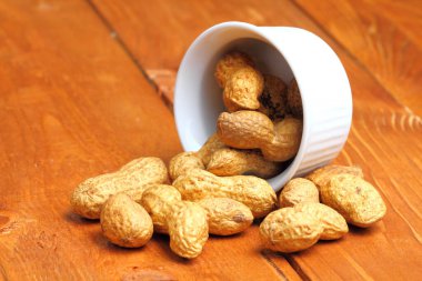 Peanut  popular, healthy, on a rustic background of wood, close-up.