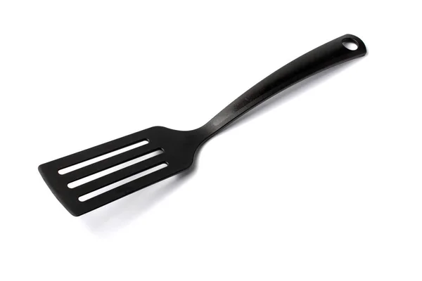 Black plastic spatula for home, white background, isolate. — Stok fotoğraf