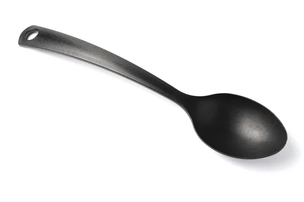 Big black plastic spoon for home, white background, isolate. — Stock Photo, Image