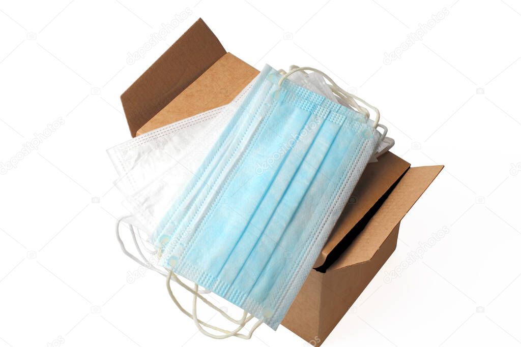 Medical masks in a box on a white background close-up, coronavirus concept and other contagious diseases.