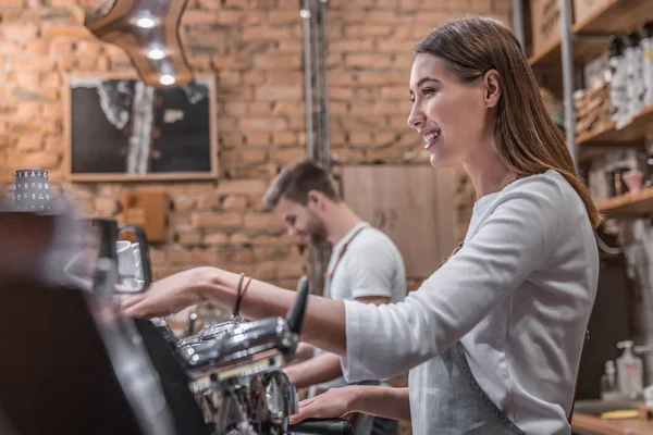 Side view shot of female barista making a cup of coffee — Stock Photo, Image