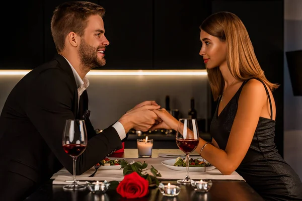 Pleased happy married couple having romantic dinner in candlelight — Stock Photo, Image