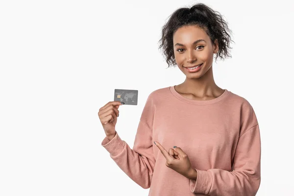 Smiling young african american girl in sweater posing isolated on white background — Stock Photo, Image