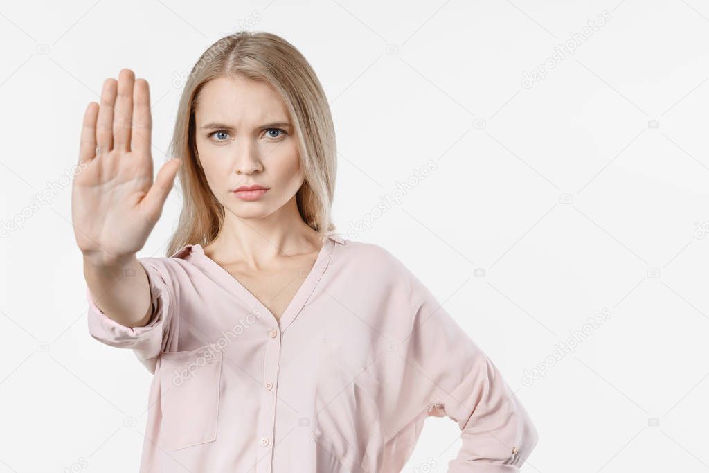 Angry woman gesturing stop sign over isolated white background
