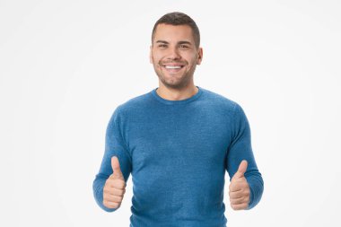 Portrait of cheerful man smiling and showing thumbs up isolated over white background