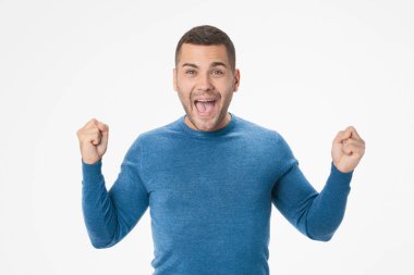 Portrait of excited young man celebrating success isolated on white background