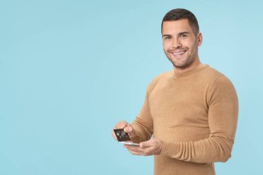 Online payment is easy.Man holding smartphone and using credit card for online shopping