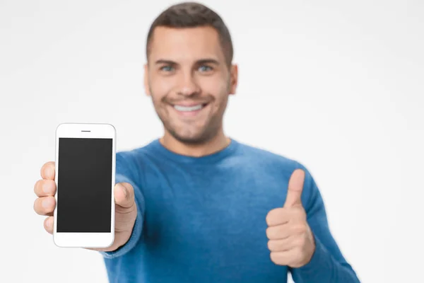 Close up portrait of happy young man with smartphone and showing ok gesture — 스톡 사진