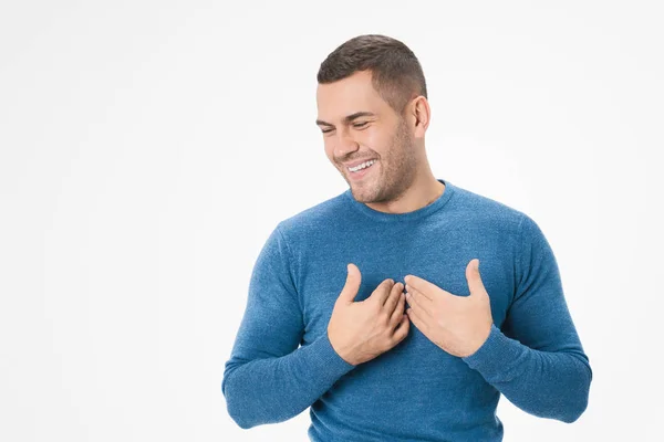 Young caucasian man has friendly expression pressing palm to chest against white background isolated — 스톡 사진