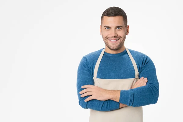 Junger gutaussehender Ladenbesitzer mit Schürze vor isoliertem weißem Hintergrund — Stockfoto