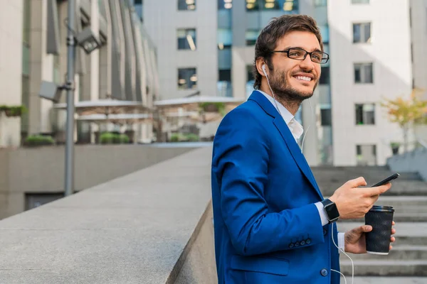 Kaukasischer Geschäftsmann Anzug Mit Ohrstöpseln Und Smartphone Beim Kaffee Freien — Stockfoto