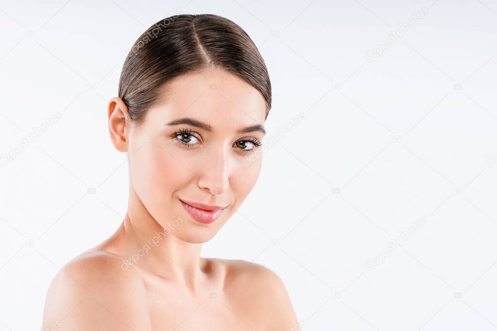 Brunette female looking at camera and smiling. Youth and skin care concept