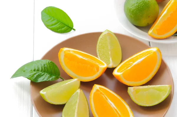 Orange slices with leaves on white — Stock Photo, Image