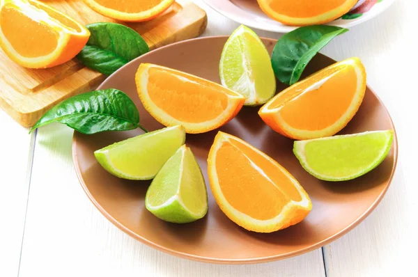 Orange slices with leaves on white — Stock Photo, Image