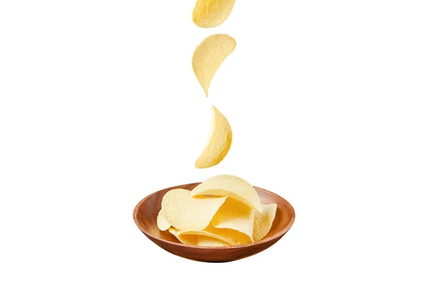 Chips in wooden plate and falling ones isolated on white background — Stock Photo, Image