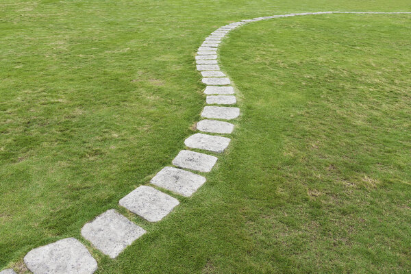 Stone Pathway on green grass. Natural background