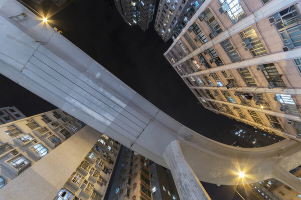 Elevated road through residential building in Hong Kong city.