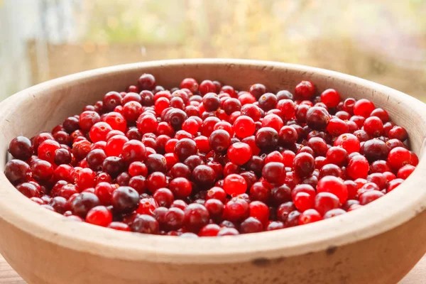 Red berries in a wooden bowl — Stock Photo, Image