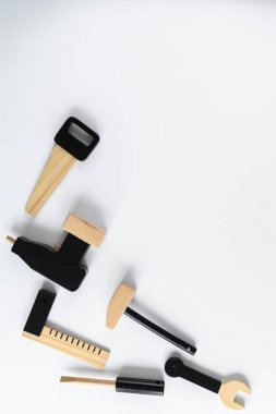 Çocuklar beyaz arka planda tahta aletler, metin için boşluk. Diy konsepti. Testere, matkap, tornavida, çekiç, anahtar altıgen.