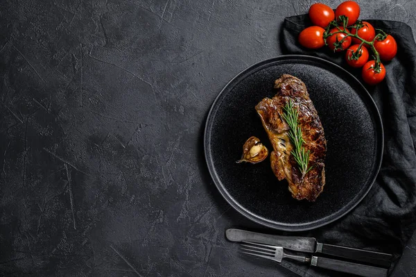 Beef sirloin steak on black background. Space for text. Marble beef.