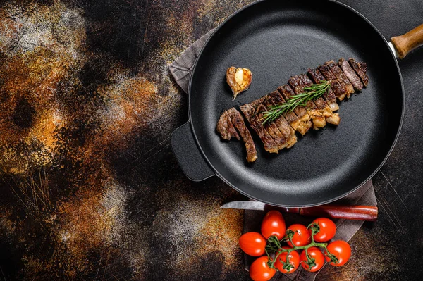 Beef sirloin steak in a frying pan. Space for text. Marble premium beef.