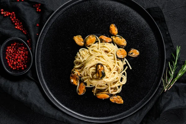 Spaghetti di pasta con cozze su fondo nero. farina di frutti di mare — Foto Stock