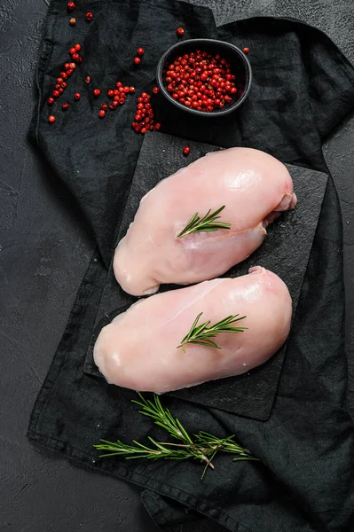 Raw chicken Breasts on a chopping Board. Fresh fillet. Black background. Space for text — Stock Photo, Image