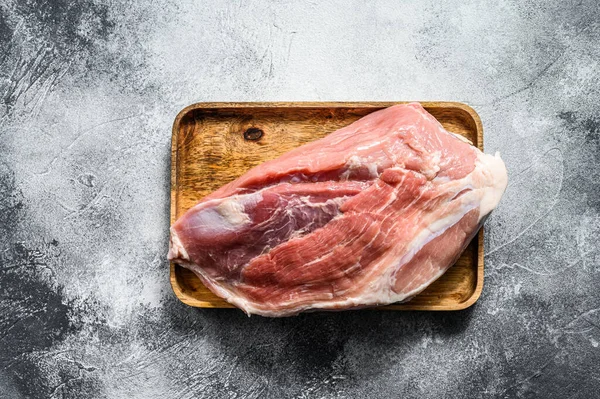 fresh pork cuts. Raw meat with spices. hind leg steak. Gray background. Top view