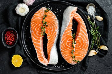 Baharatlı taze somon bifteği. Atlantik balığı. Siyah arka plan. Üst görünüm