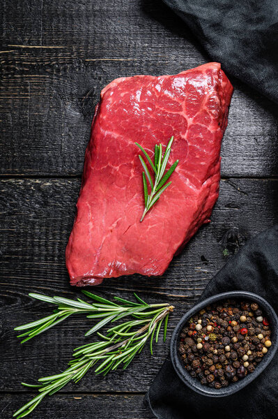 Raw strip loin steak. Beef meat. Black background. Top view