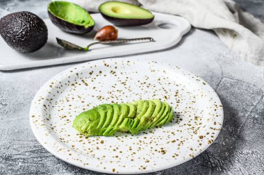 Doğranmış yeşil avokado. Gri arka plan. Üst görünüm