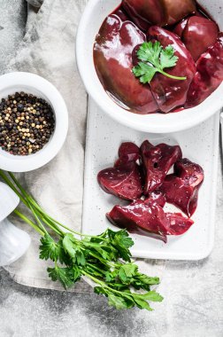 Tabakta çiğ hindi ciğeri. Gri arka plan. Üst görünüm