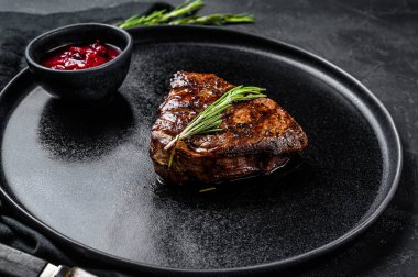 Grilled filet Mignon steak. Beef tenderloin. Black background. Top view clipart