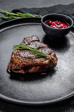 Grilled filet Mignon steak. Beef tenderloin. Black background. Top view clipart