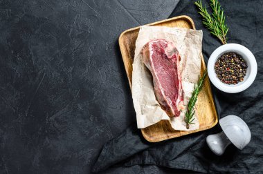 Kemiğe sığır eti, sığır filetosu. Siyah arka plan. Üst Manzara. Metin için boşluk