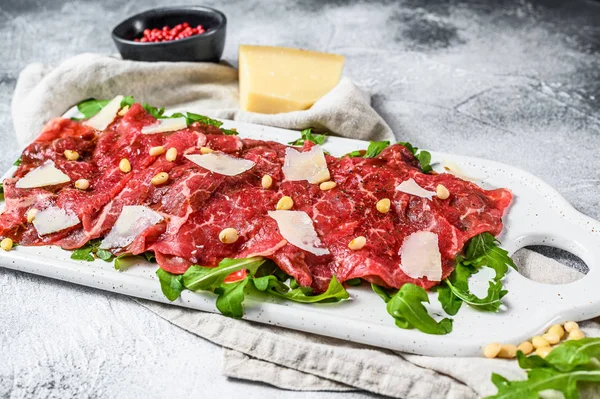 Carpaccio of marbled beef. Raw meat black Angus. Gray background. Top view — Stock Photo, Image